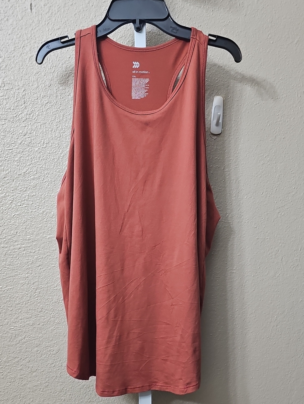 All in motion rust colored or terracotta-shaded women’s racerback tank top